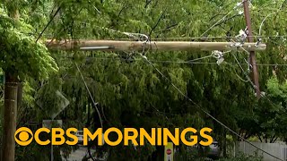 Storms knock out power across East Coast as heat wave builds