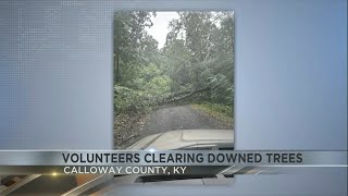 Volunteers clearing downed trees in Kentucky after storms