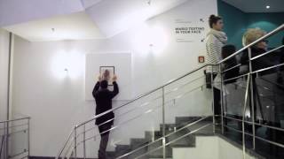 Vermibus hanging an artwork in the Mario Testino exhibition "In Your Face"