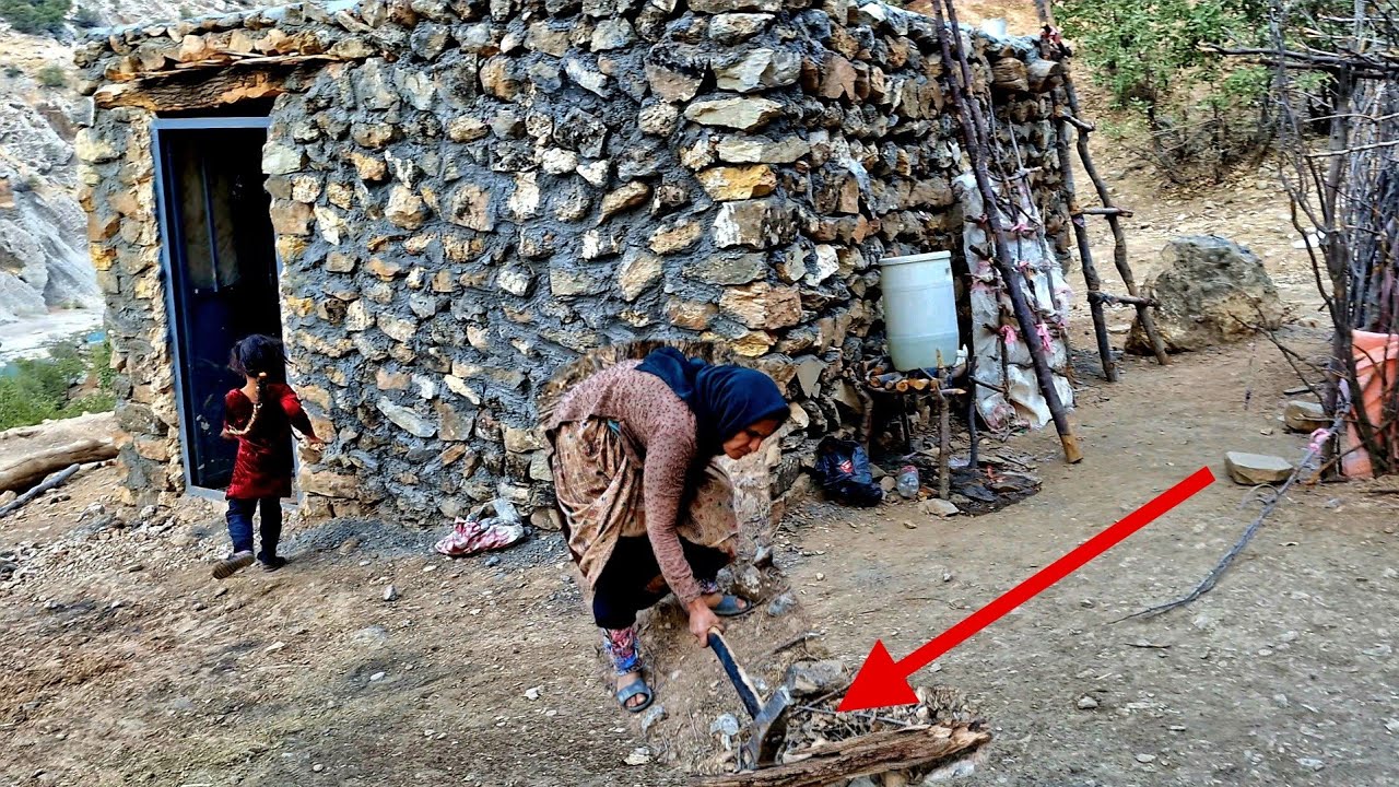 A nomadic mother in the mountains chops firewood for her winter. - YouTube