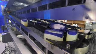 Serpentine Cooling Conveyor - Lids Open & Containers Oriented