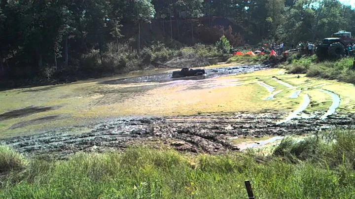Truck trying to make it threw pond