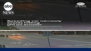 Speeding car narrowly avoids hitting girl on scooter
