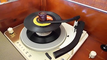 Philco record player playing a stack of 45 records.