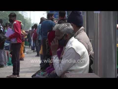 Passengers wait for buses at AIIMS bus stop in New Delhi