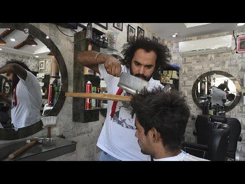 Pakistan barber offers hair-raising cuts with cleavers and blowtorches