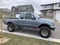 First Gen Toyota Tacoma with 3” lift off-roading in the mud