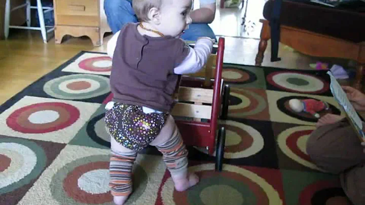 Wilhelmina "walking" with the radio flyer.... 6 mo...