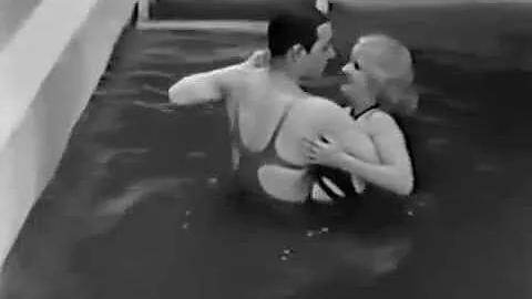 George Raft dances in the swimming pool with Gertr...