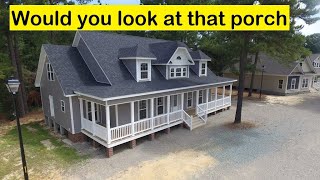 Large wrap around porch on this cape style 2 story modular home. (prefab)