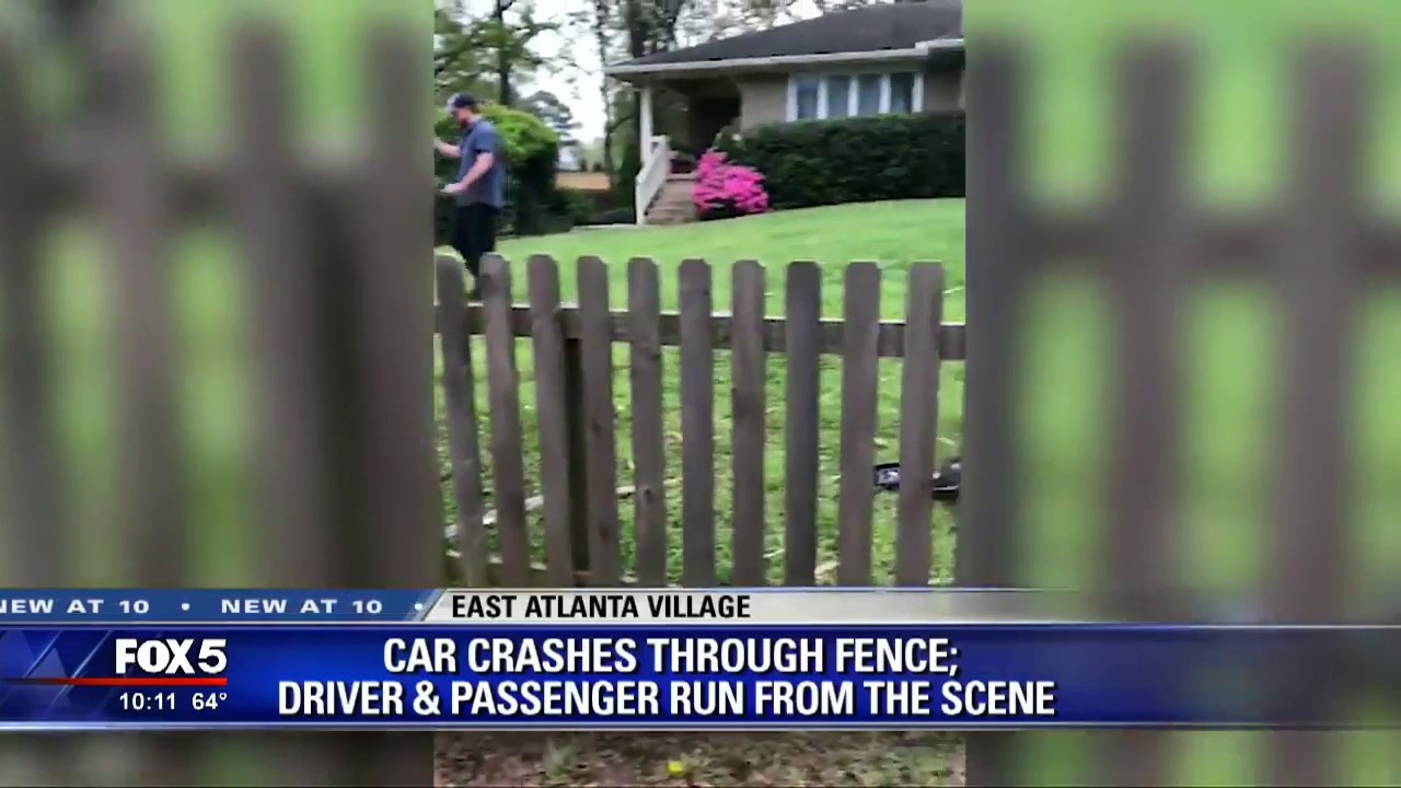 Car crashes through fence