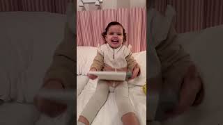 Toddler loving her book with ￼horses