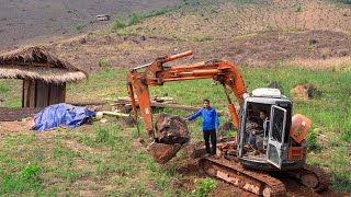 The process of an excavator digging a road to the farm and cutting grass for the pigs | Family farm 