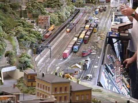***Watch in High Quality for Best Results*** (Part Six) June 26, 27, and 28 was Railfest weekend in Altoona, Pennsylvania. This video is of two great train layouts. One of the layouts was on the third floor of the Railroaders Memorial Museum, and the other was about halfway between the Railroaders Museum, and the Horseshoe Curve. The layout on the third floor of the Railroaders Museum was a modular layout. Some of the features on that it included, the Horseshoe Curve, the Gallitzin Tunnels, the Portage Tunnel, and a small train yard. It was a very cool layout. The other layout was at the Altoona Association of Model Railroaders and Museum. The layout is made up of both HO and O gauge. The outside is O, and the inside is HO, with an HO village and town. The building is small, but the club used every inch they could use to build the beautiful layout. Me and Matt (CSX2788) took the shuttle bus that the Railroaders Museum provided for the weekend, which ran from the Railroaders Museum, to the Altoona Association of Model Railroaders and Museum, and then to the Horseshoe Curve where it then ran back to the Railroaders Museum from there. Anyways, I stepped outside of the train club to talk a picture of the sign, and to see if our bus was here, when I heard a train blowing its horn for the near-by "Brick Yard" crossing. Matt (CSX2788) was standing next to me and we both knew it sounded like the E8's coming back to downtown Altoona with the 12:20 excursion train. So thinking we <b>...</b>