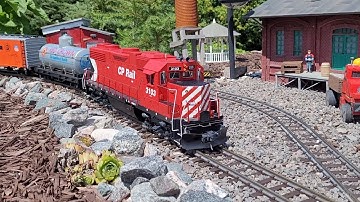 GP38-2 running mixed manifest train  in the garden