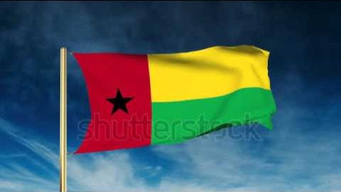 Guinea-Bissau flag slider style. Waving in the wind with cloud background animation Stock video by