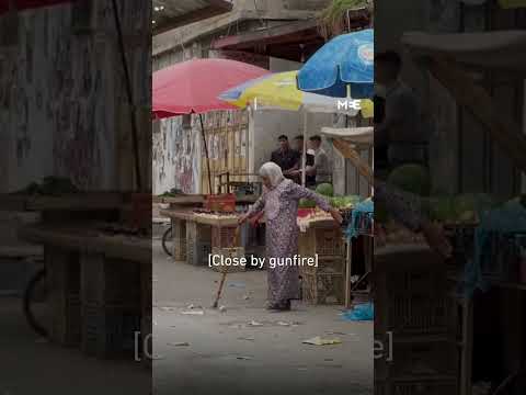 Elderly Palestinian woman braves gunfire from Israeli raid to cross the street