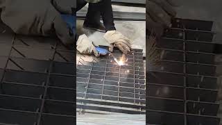 welding metal steel grate using gas metal arc welding machine with orange sparks flying around