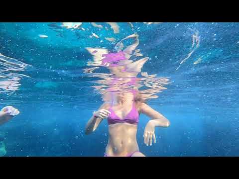 two beautifull girls swimming underwater with nice Swimsuit