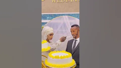 bride and groom cake eating in style