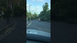 Girl on skateboard bombs hill then tries running to stop herself but falls and lands on pavement