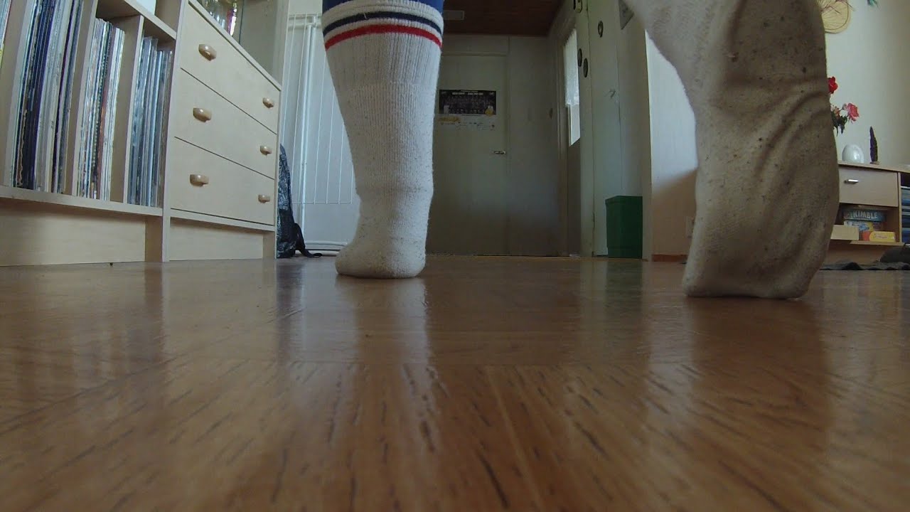 walking on the floor wearing dirty white tennis socks and rubbing socks on the floor (Tube socks)
