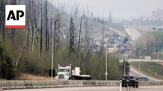 Canadian officials hope shifting winds will aid wildfire fight in Alberta
