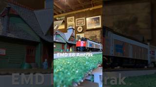 Ho scale model Amtrak train speeding by the station