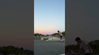 Girl on roller skates grinds handrail at skatepark then falls and lands on stomach