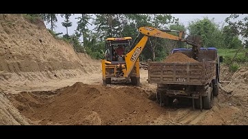 Jcb Backhoe machine cutting hill and loading soil in  tractors