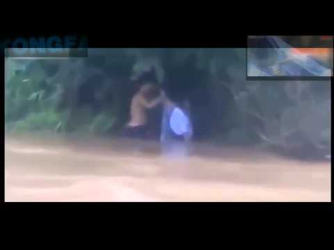 Vietnamese Father takes his kids across a flooded river in a PLASTIC BAG