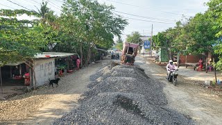Process repair old road in village spreading gravel by mini Komatsu d20p dozer & 12wheel dump truck