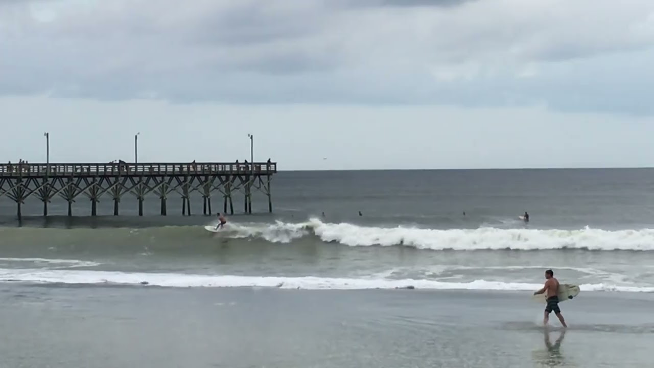Surfer at Holden Beach Pier