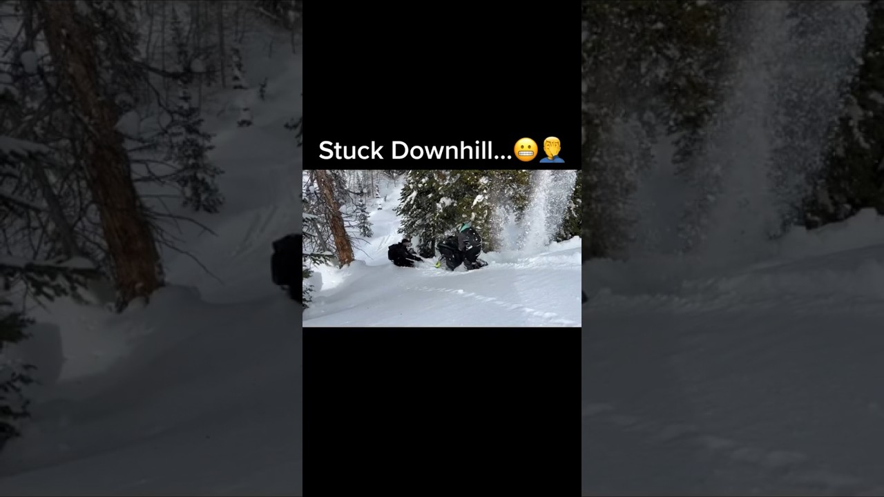 Snowmobile stuck going down hill