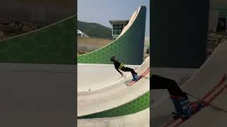 Kid on skis attempts backflip from Water ramps at the Utah Olympic park and hits back of his head