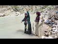 Fishing in the raging river by a young nomadic woman