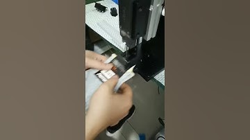 Automatic socks tag attaching machine