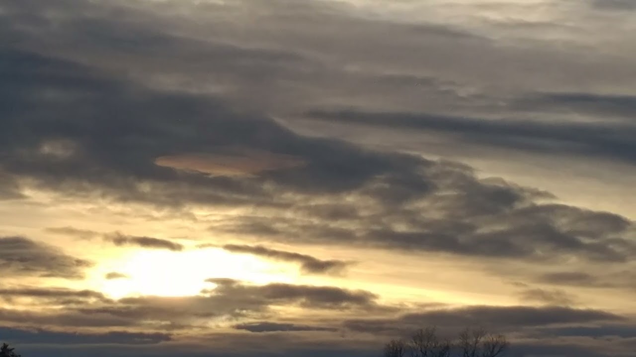 Bright Golden Sunlight Shines Through The Dark Clouds Ahead Of The Sunset