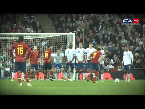 Scott Parker won the Man Of The Match after a strong defensive and all round display against the Worls Champions. FATV captured a fine moment from the Spurs midfielder as he put his body on the line to stop a dangerous VIlla free kick. England picked up a memorable win at Wembley in their first outing since a place at UEFA EURO 2012 was secured as World and European Champions Spain were put to the sword by Fabio Capello's men. On the day the Lord Mayor's Show took place on the streets of London, it was far from a let down as a hardened and determined display from the Three Lions saw them inflict a rare defeat on a strong Spanish line-up. The match-winner arrived early in the second half, when captain Frank Lampard headed home from close range and whilst the visitors made a valiant effort to get themselves back level, the true English spirit shone through with some characteristic hard work, courage and expert defending. In fact, the rearguard performed admirably for Capello's side throughout and England could claim to have been more than equal to their illustrious opponents for large parts of the match. As expected though, Spain pressed England high up the pitch from the very start which gave the defence plenty to think about, but at the same time also left swathes of room for midfielders Phil Jones and Lampard to break into when the Three Lions won the ball. With man-of-the-match Scott Parker doing a fine job of picking up the pieces in front of the back four, it was <b>...</b>