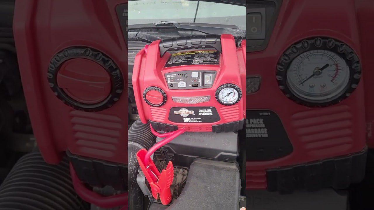 Boosting your car with a portable booster pack. Motomaster 1933 model. 