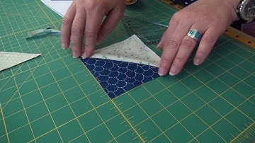 Pat Sloan Trimming Half Square Triangles withe the Folded Corner Clipper