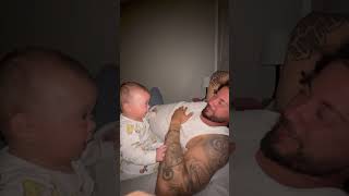 Toddler Laughs as Father Gently Puts His Hand on Her Face
