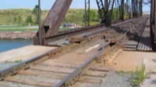 Swing bridge in action A swing bridge swinging closed, train goes over, and opens again.