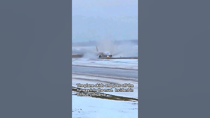 The plane skids and goes off the runway into the mud.  Incident in Vilnius Lithuania.