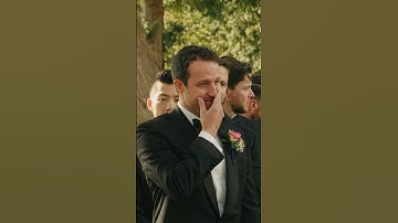 Groom crying when he sees his beautiful bride walking down the aisle during their wedding ceremony