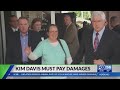 Kim davis to pay damages to 1 couple after lawsuit
