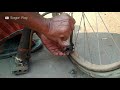 Rickshaw puller in dhaka, Bangladesh - pump up his rickshaw tyre manually