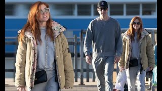 Isla Fisher wears one shoe as she goes for a romantic lunch in Sydney with Sasha Baron Cohen