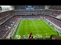 A thrilling soccer match in a massive stadium filled with enthusiastic fans.