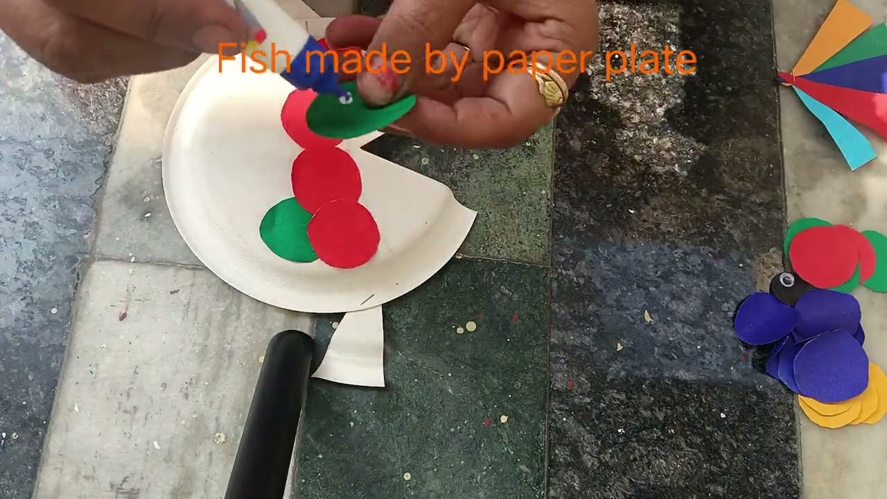 Fish made by waste paper plate waste material craft.